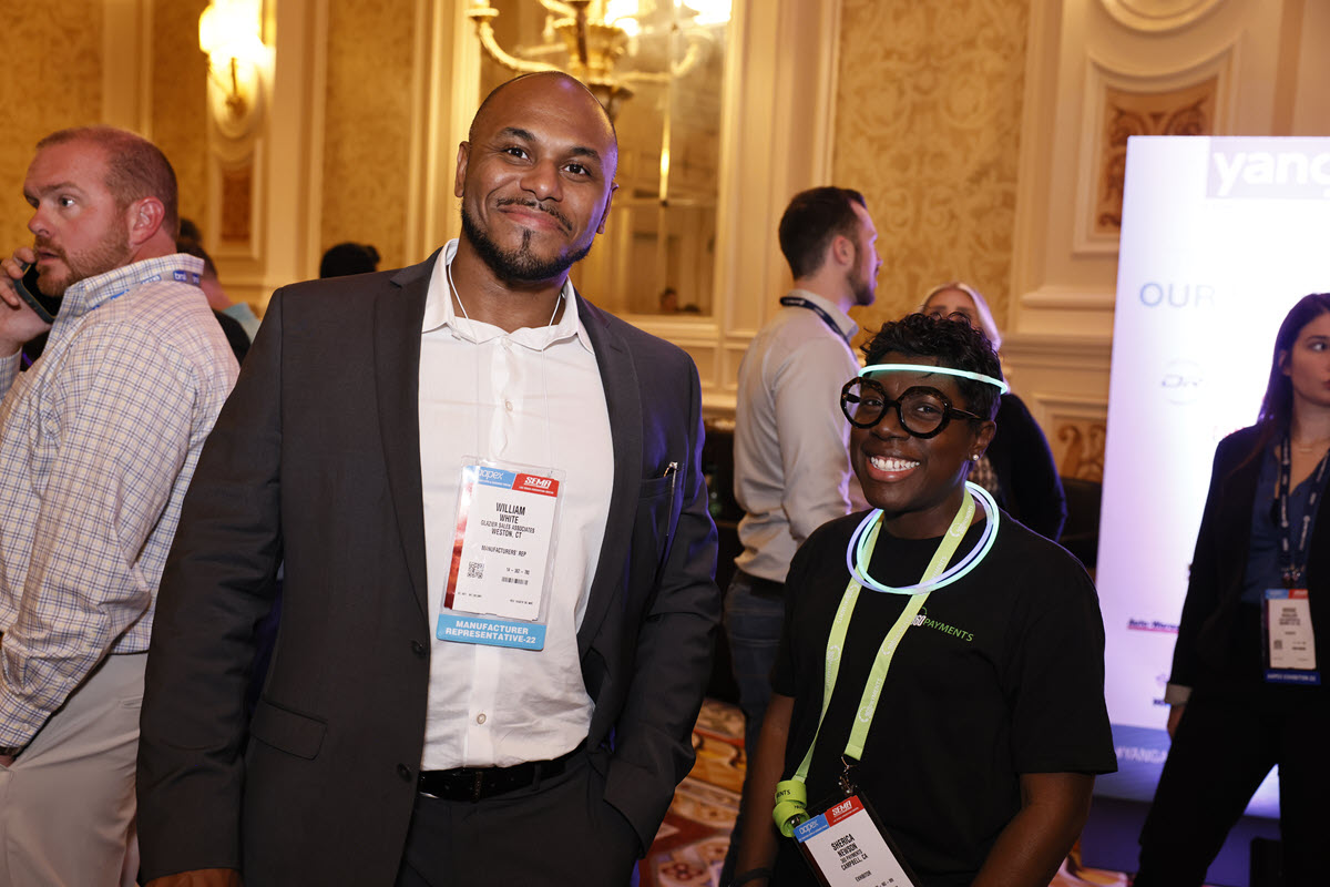 Attendees smile at an evening reception